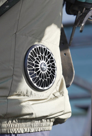 Close-up of an AC wear jacket fan with a brand logo on a blurred background