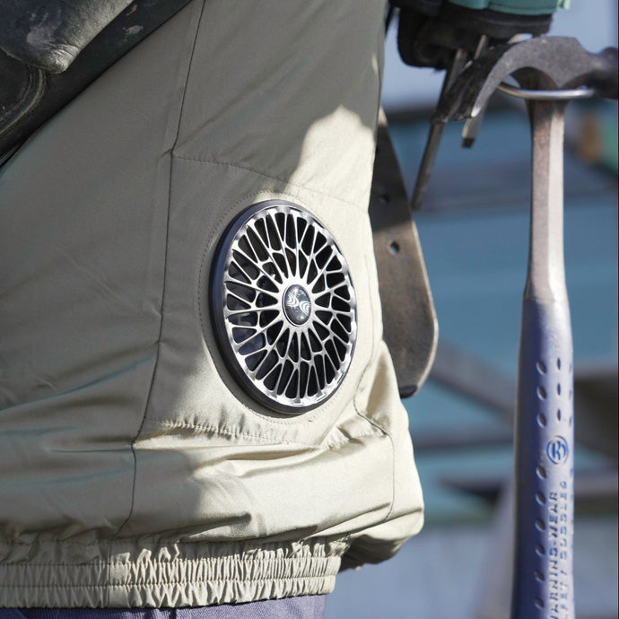 Close-up of an AC wear jacket fan with a brand logo on a blurred background